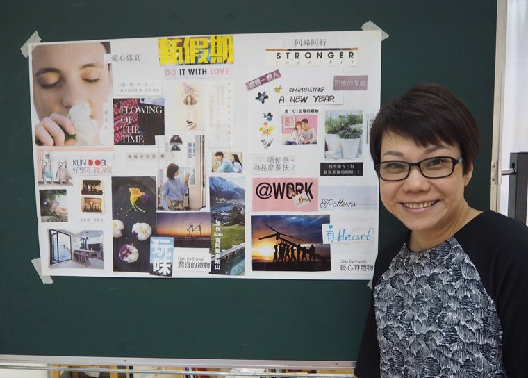 A trainer standing beside a vision board made of pictures and words